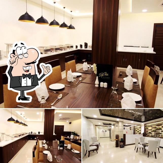 Take a seat at one of the tables at Spice Kitchen- The Sizzling Multi-Cuisine Restaurant