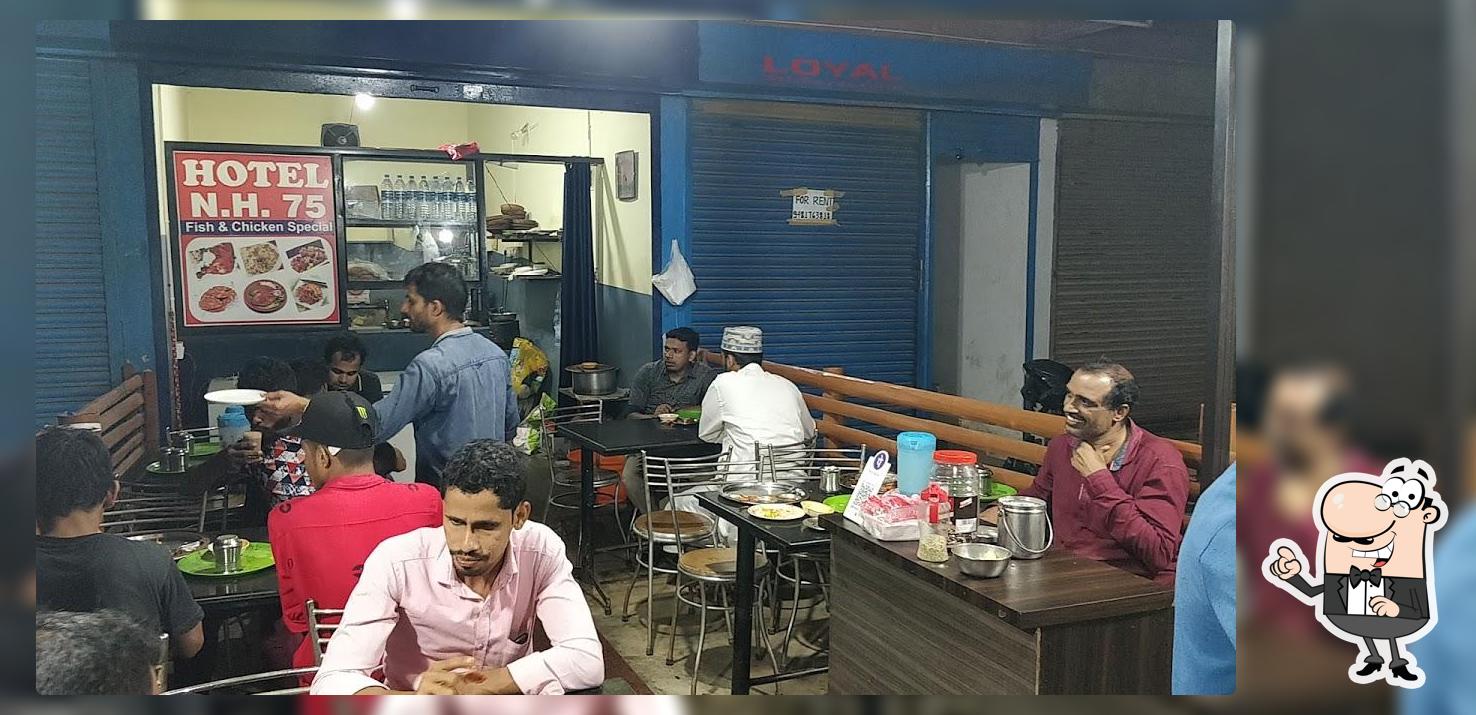 Take a seat at one of the tables at HOTEL NH-75
