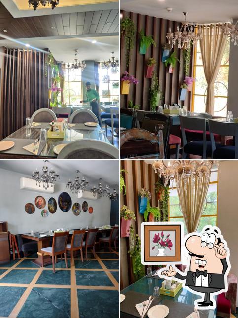 Take a seat at one of the tables at RD'S Infusion Global Veg Kitchen Fine Dining Restaurant