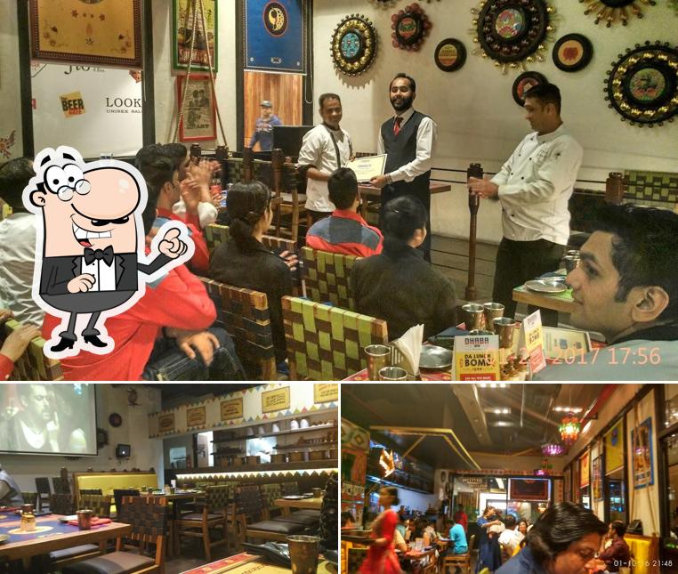 Take a seat at one of the tables at Dhaba Estd 1986, Nehru Place