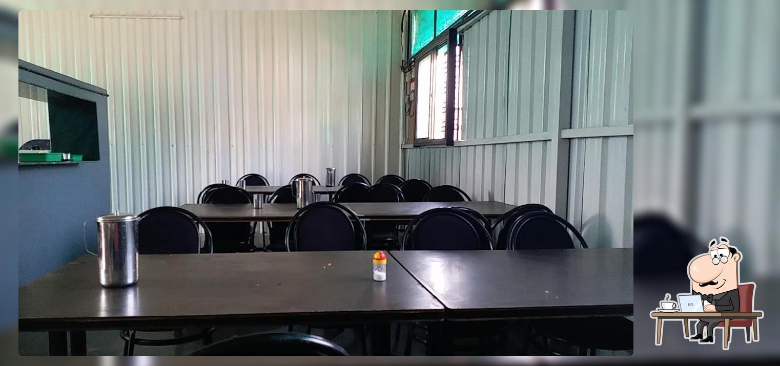 Take a seat at one of the tables at Samarth Cafe & Xerox Centre