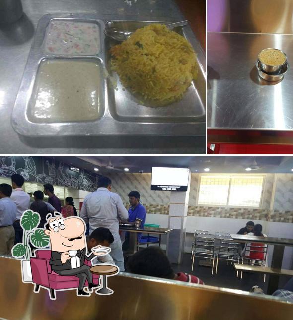 Take a seat at one of the tables at Ajantha Restaurant