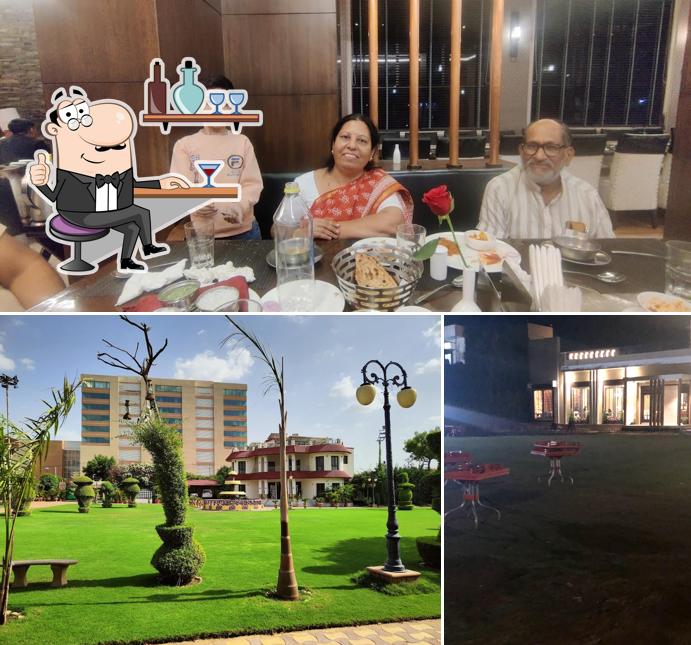 Take a seat at one of the tables at The Grand Turf Pure Vegetarian Family Restaurant