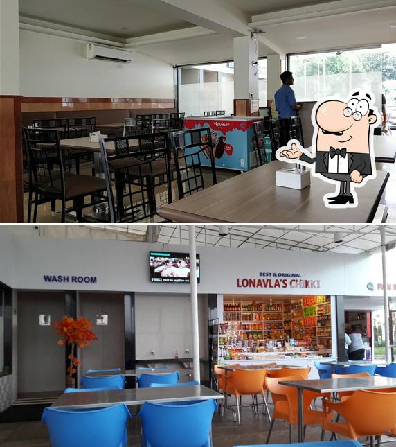 Take a seat at one of the tables at Taujis Food Plaza ( Pure Veg. Restaurant / Jain food )