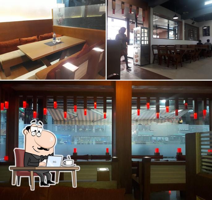 Take a seat at one of the tables at RICE N ROTI RESTAURANT