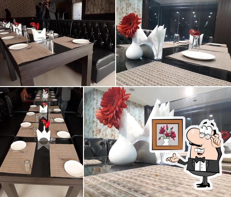 Take a seat at one of the tables at La Vie restaurant And cafe lounge