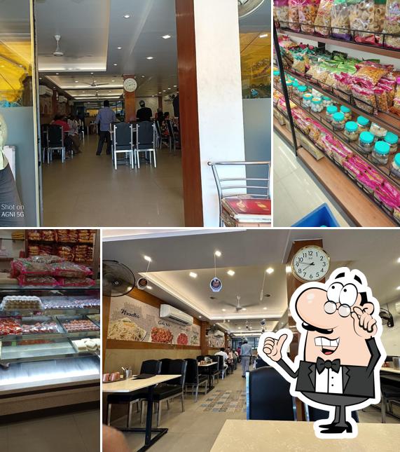 Take a seat at one of the tables at Aswins Sweets & Snacks (K K Nagar - TRY)