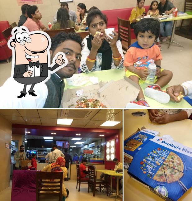 Take a seat at one of the tables at Domino's Pizza Shahdara,, New Delhi