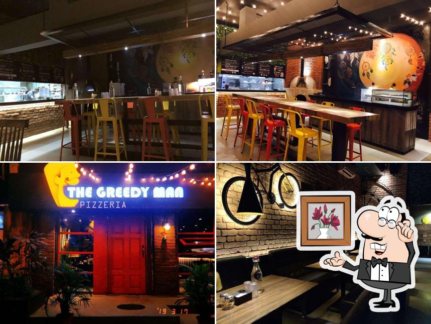 Take a seat at one of the tables at The Greedyman Pizzeria