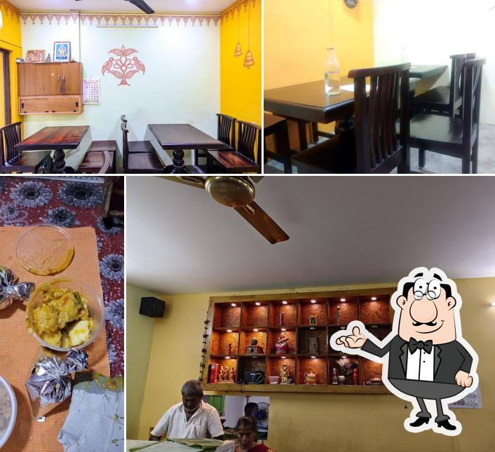 Take a seat at one of the tables at Atherai Veg Restaurant A/C