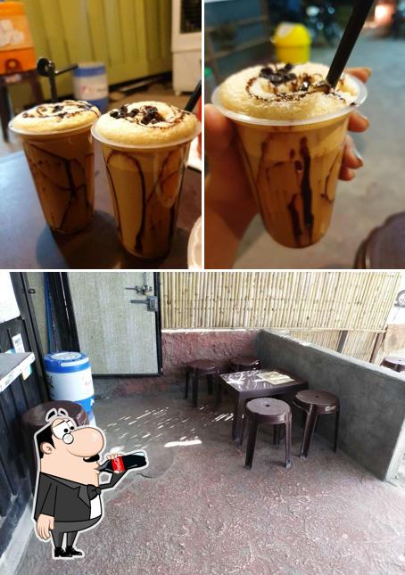 Take a look at the image depicting drink and interior at Olive's Cafe