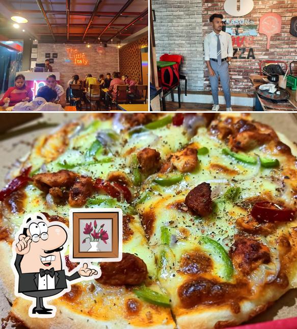 Among different things one can find interior and pizza at Laziz Pizza and Biryani, Dhubri