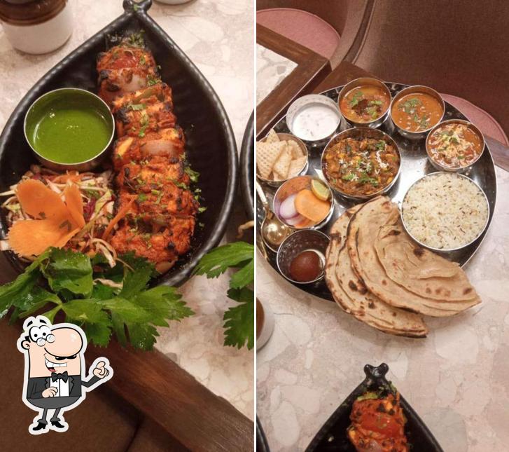 Take a seat at one of the tables at Indian Thali House (Pure Veg) CBD Belapur