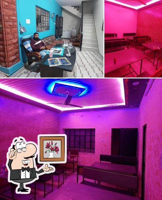 Take a seat at one of the tables at Jodhpur Veg, Non-Veg & Fast Food Restaurant