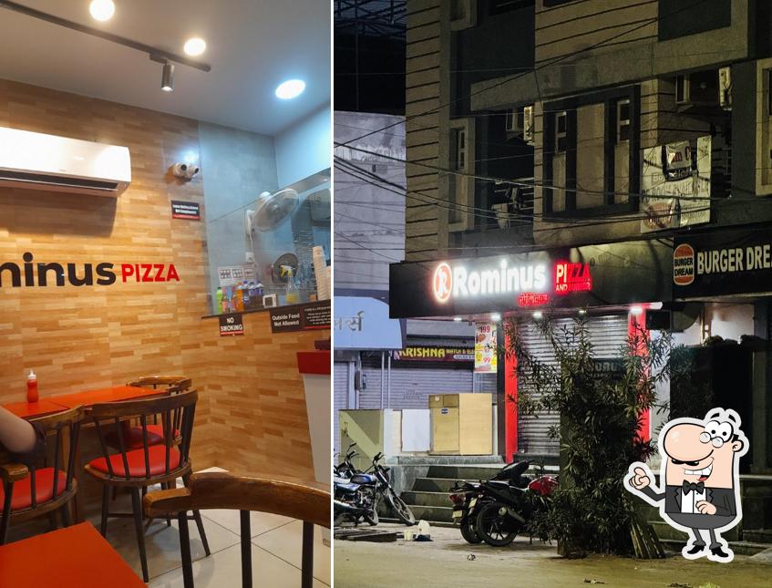 Take a seat at one of the tables at Rominus Pizza And Burger