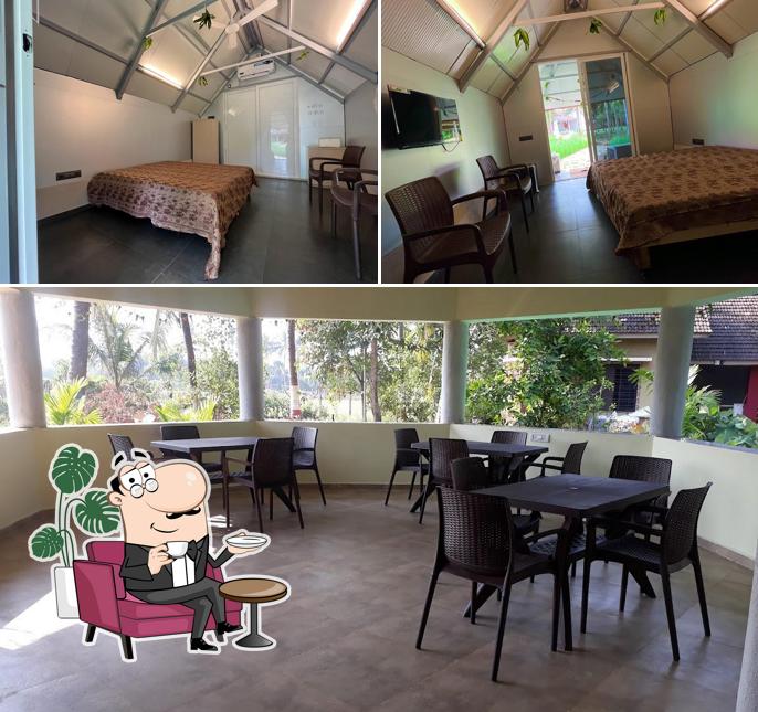 Take a seat at one of the tables at Laxmi Chayaa, Lodging and Boarding