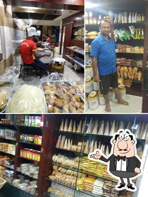 Take a seat at one of the tables at AITHAL Holige Mane