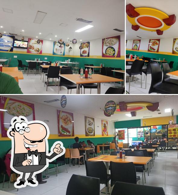 Take a seat at one of the tables at BUHARI FOOD COURT