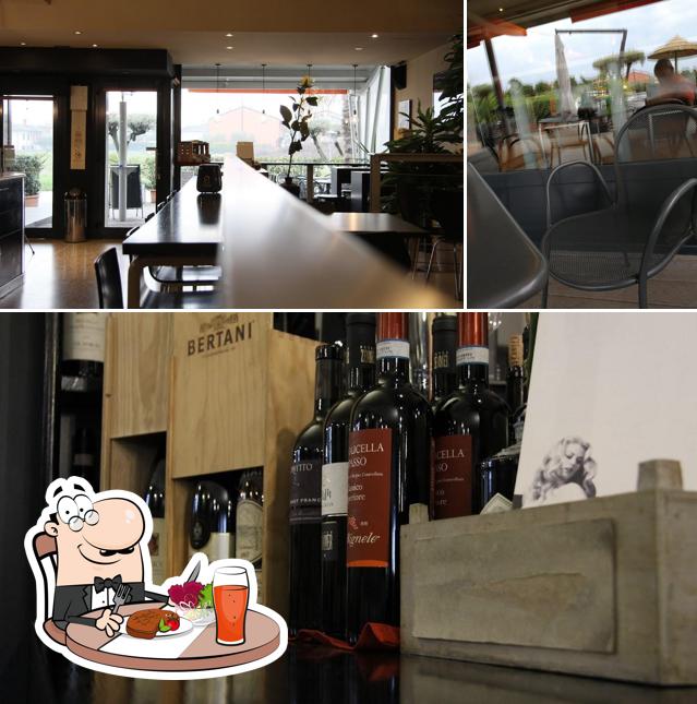 Guarda la foto che raffigura la tavolo da pranzo e vino di La Dolce Vita Caffè