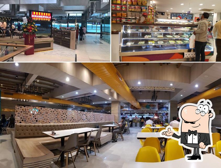 Take a seat at one of the tables at Bikanervala Karol Bagh