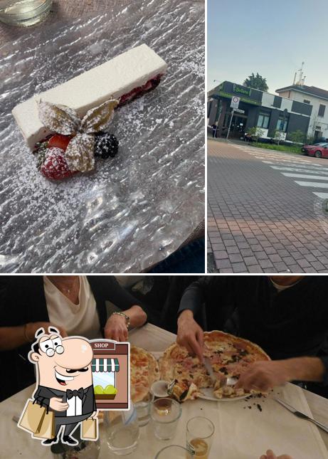 Questa è la foto che presenta la esterno e tavolo da pranzo di Pizzeria Dollaro