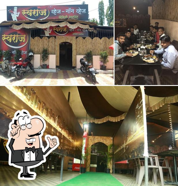 Take a seat at one of the tables at Swaraj Veg-Non Veg Family Restaurant