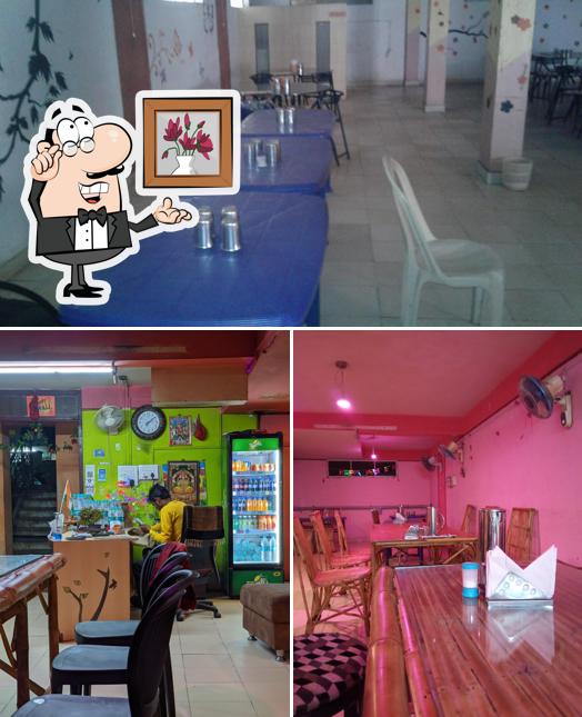 Take a seat at one of the tables at Pink Rajasthani Family Restaurant and Dhaba