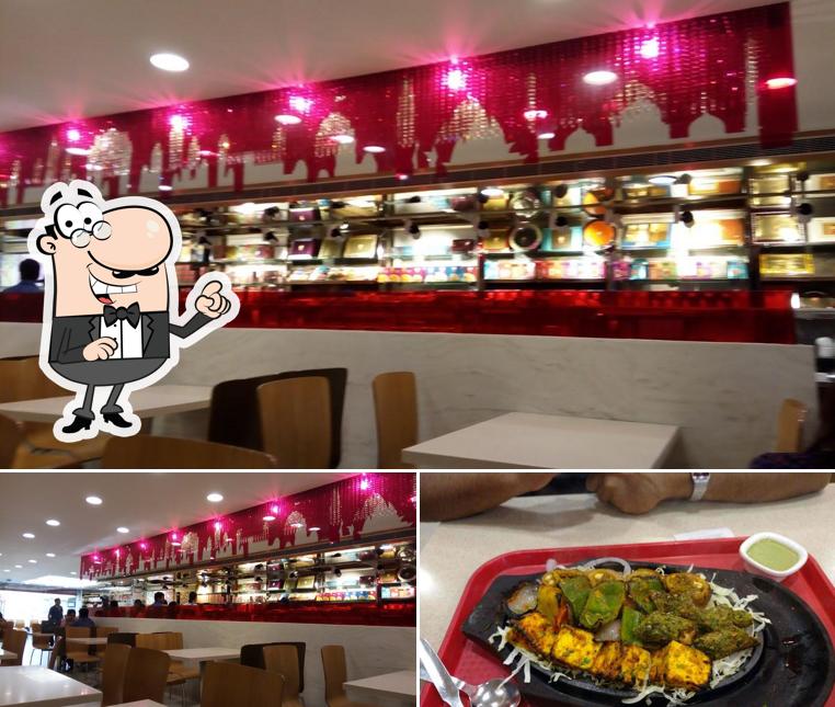 This is the image showing interior and food at Anand Sweets - Bannerghatta