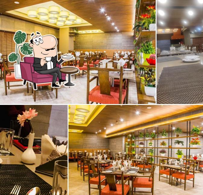 Take a seat at one of the tables at Olive Restaurant