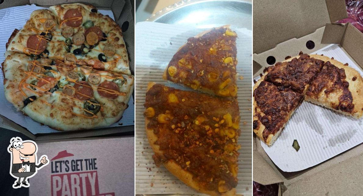 Take a seat at one of the tables at Pizza Hut Nipania, Indore