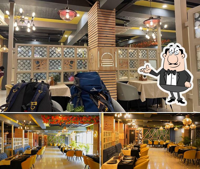 Take a seat at one of the tables at Dalchini Restaurant