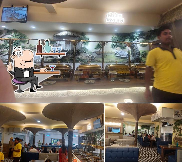 Take a seat at one of the tables at Mata Ji Ki Rasoi Pure Veg Unlimited Buffet Restaurant