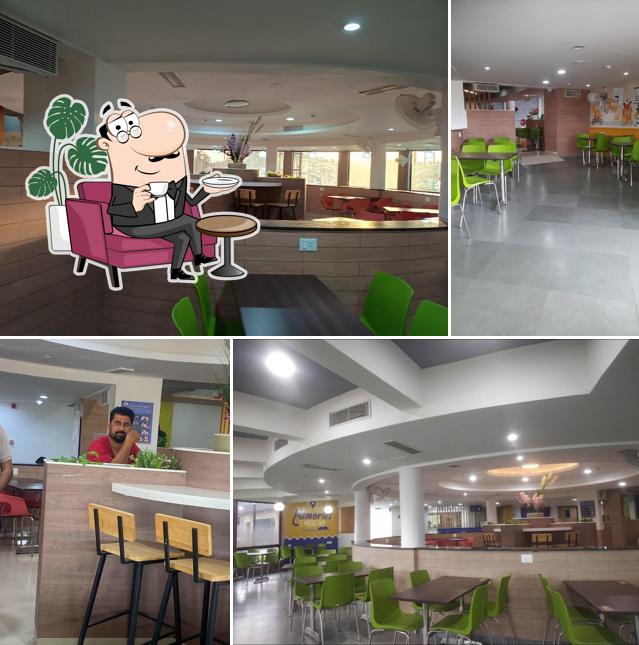 Take a seat at one of the tables at Cube Stop Muti-Cuisine Highway Restaurant