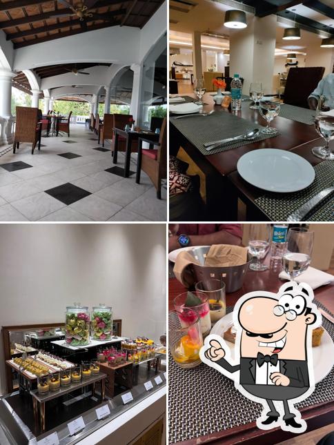 Take a seat at one of the tables at Keraleeyam Restaurant at The Leela Ashtamudi- A Raviz Hotel