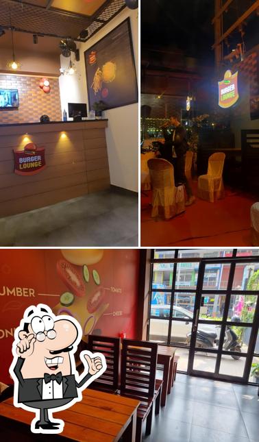 Take a seat at one of the tables at Burger Lounge Ramanattukara