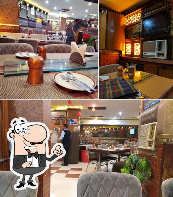 Take a seat at one of the tables at CHULA CHOWKA Restaurant