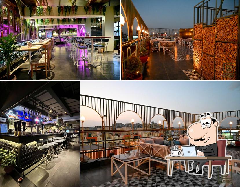 Take a seat at one of the tables at Barrio Rooftop, AC Restaurant & Bar - Pimple Saudagar