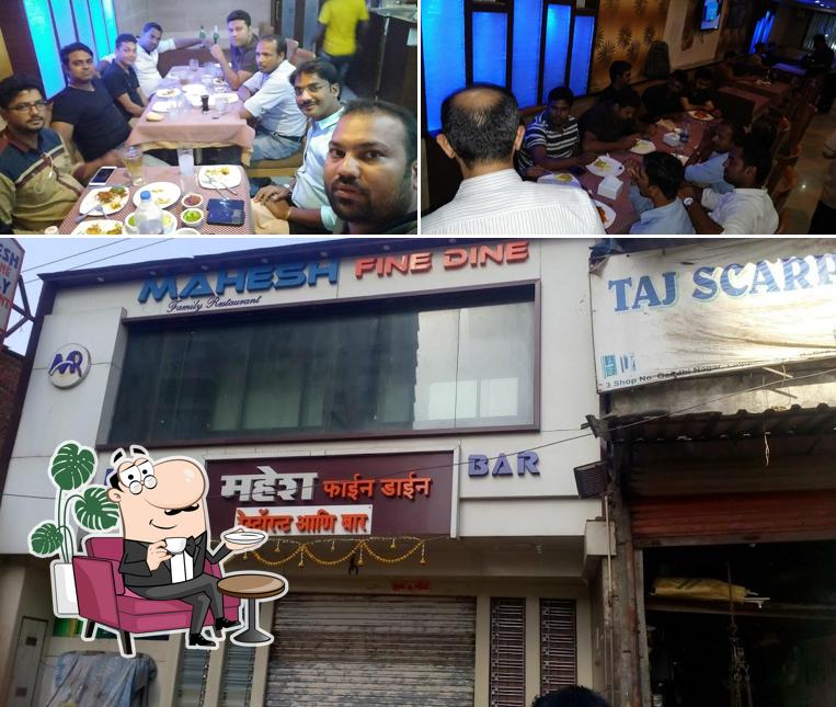 Take a seat at one of the tables at Mahesh Fine Dine Family Restaurant & Bar