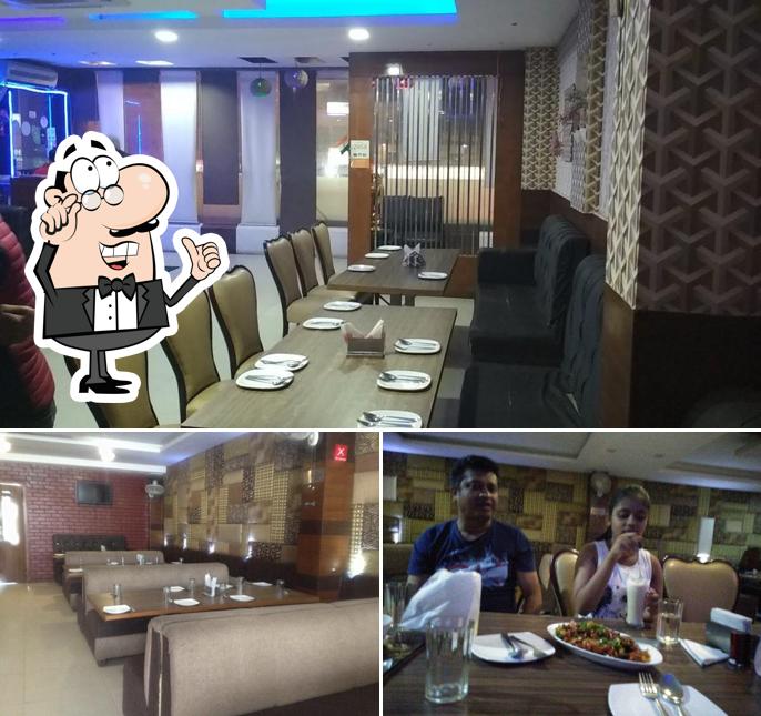 Take a seat at one of the tables at Lemon Chilli, Fine Dine Restaurant