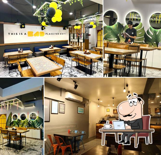 Take a seat at one of the tables at Size Zero Cafe Restro