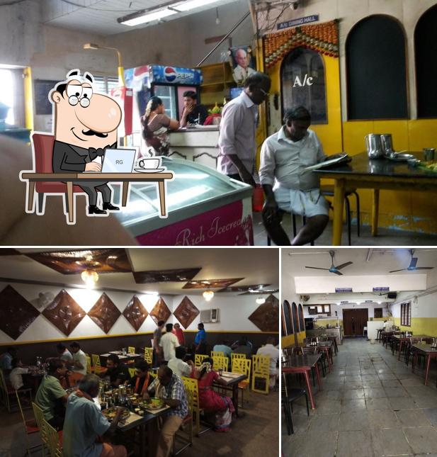 Take a seat at one of the tables at ASHOK BHAVAN - Veg Restaurant