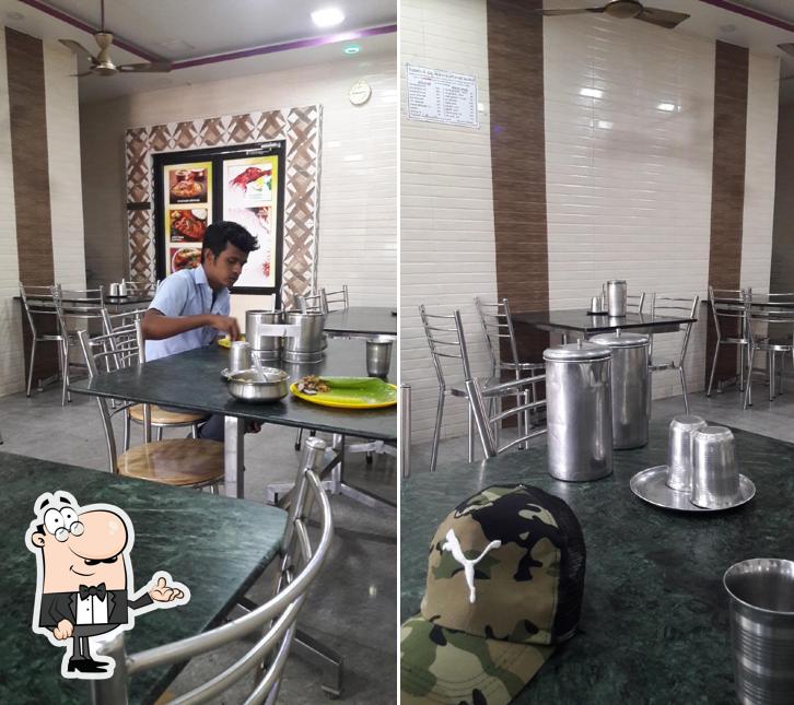 Take a seat at one of the tables at Arcot Hotel