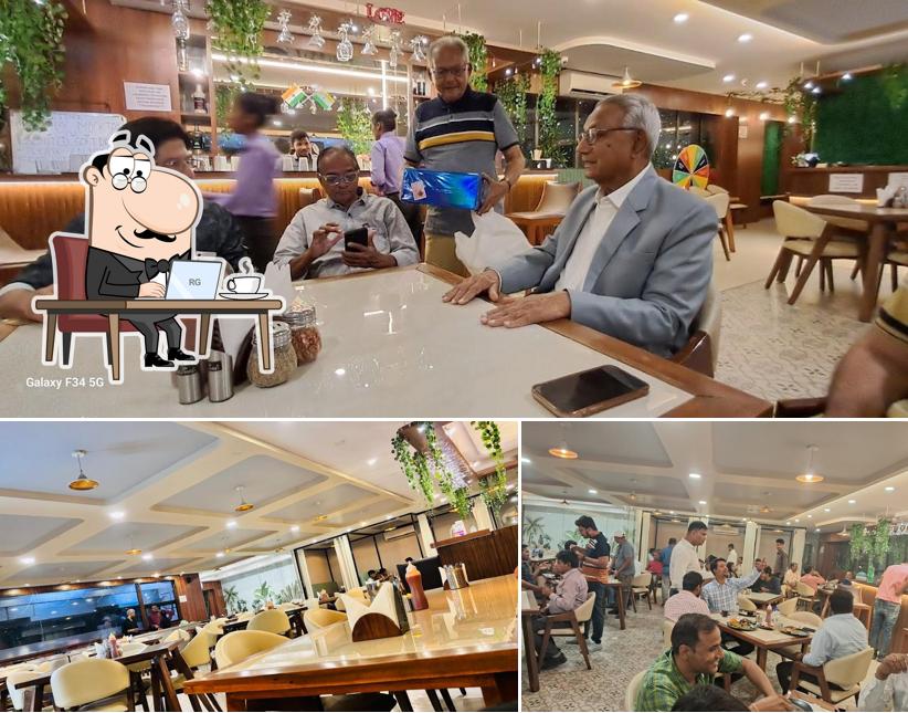 Take a seat at one of the tables at New taste & flavour veg & non veg