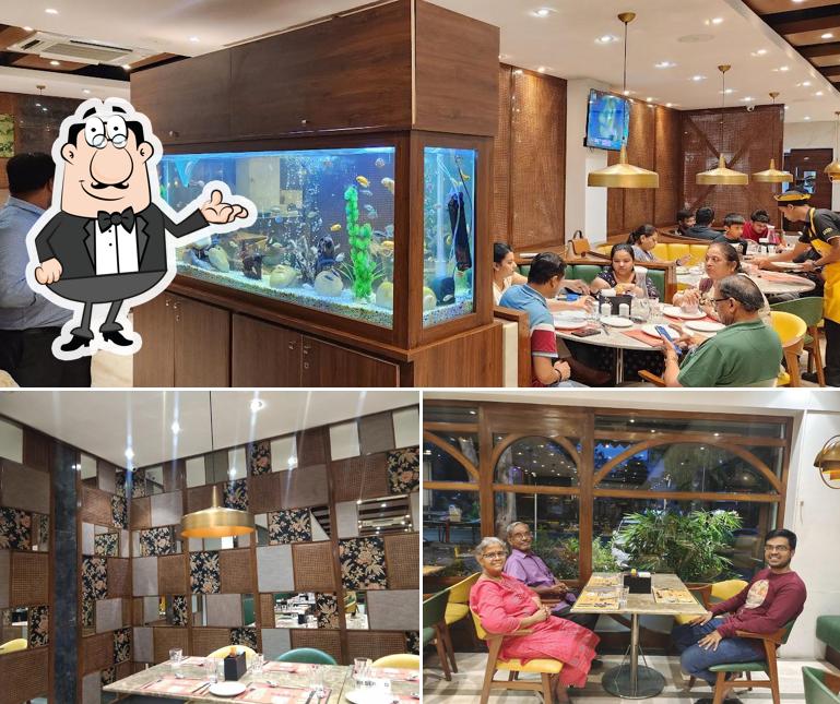 Take a seat at one of the tables at Sazzy Sizzlers (Pure-Veg)