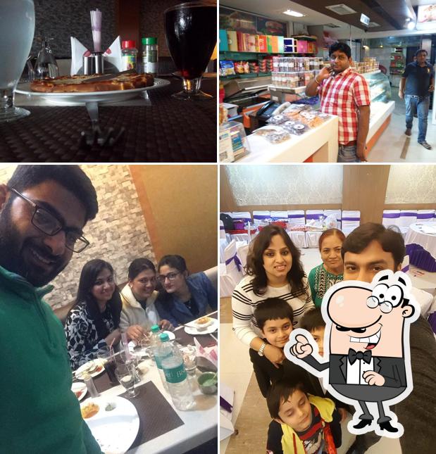 Take a seat at one of the tables at Nathu's Sweets & Restaurant