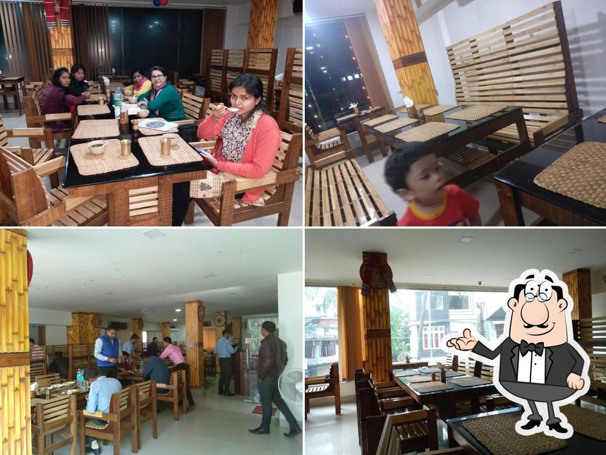 Take a seat at one of the tables at Chang-ghar Assamese Ethnic Restaurant