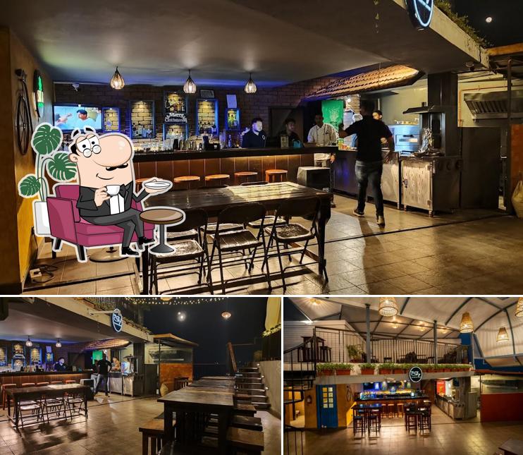 Take a seat at one of the tables at SinQ Sky The Rooftop Lounge