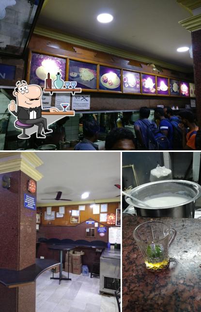 Take a look at the photo displaying interior and beverage at Tourist Tiffins