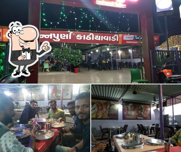 Take a seat at one of the tables at Maa Annpurna Hotel