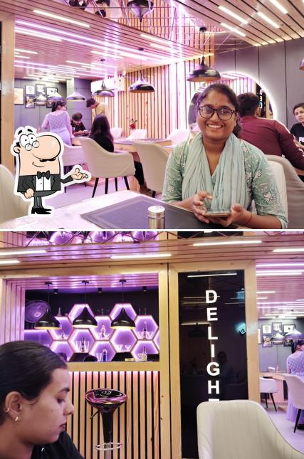 Take a seat at one of the tables at Dark Delight Restaurant & Cafe